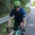 Person smiling while riding a celeste-colored Bianchi road bicycle